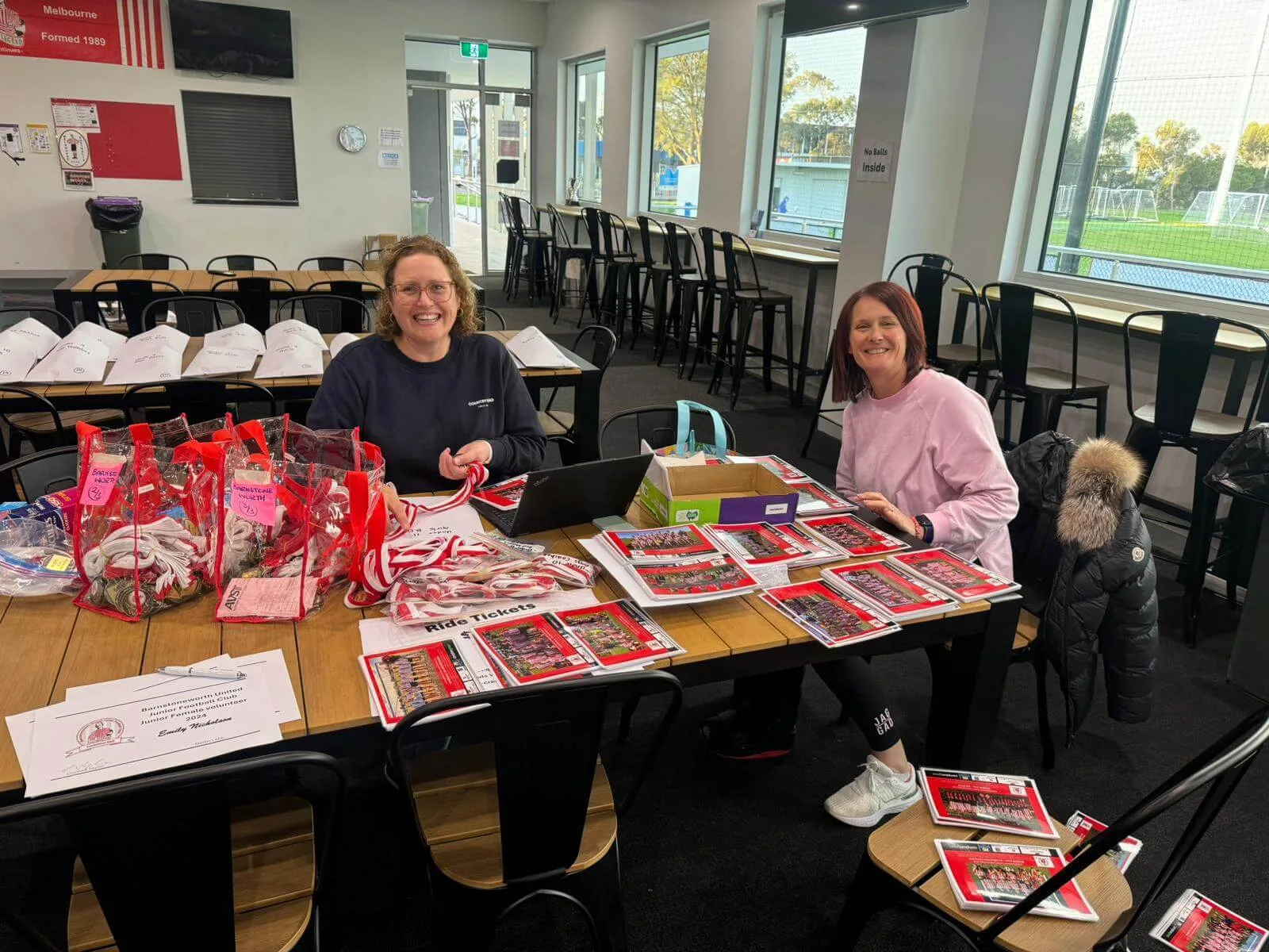 Barnstoneworth United volunteers preparing show bags and programs in the clubrooms